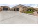 Beautiful single story home with a large concrete driveway and an attached two car garage at 8369 Eagle Estates Ct, Las Vegas, NV 89131
