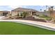 Inviting home with lush green lawn, beautiful landscaping, and a stone bench at 8369 Eagle Estates Ct, Las Vegas, NV 89131