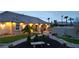 Charming home featuring meticulous landscaping, beautiful stone accents, and inviting outdoor lighting at 8369 Eagle Estates Ct, Las Vegas, NV 89131
