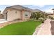 Well-maintained home with lush landscaping, manicured lawn, and brick walkway at 8369 Eagle Estates Ct, Las Vegas, NV 89131