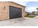 Detached garage showcasing stone facade, adjacent to backyard pool and grassy lawn at 8369 Eagle Estates Ct, Las Vegas, NV 89131