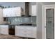 Modern kitchen with stainless appliances, subway tile backsplash and pantry at 8369 Eagle Estates Ct, Las Vegas, NV 89131