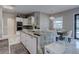 Eat-in kitchen featuring counter seating, stone countertops and modern appliances at 8369 Eagle Estates Ct, Las Vegas, NV 89131