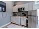Bright kitchenette featuring white cabinetry, stainless steel appliances, and modern countertops at 8369 Eagle Estates Ct, Las Vegas, NV 89131
