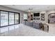 Open living room with access to the pool, a linear fireplace, and plush, comfortable seating at 8369 Eagle Estates Ct, Las Vegas, NV 89131