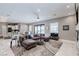Open living space features a modern kitchen, dining area, and comfortable seating with a view of the pool at 8369 Eagle Estates Ct, Las Vegas, NV 89131