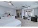 Spacious main bedroom featuring plush carpet, a ceiling fan, and sliding glass doors at 8369 Eagle Estates Ct, Las Vegas, NV 89131