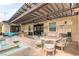 Inviting outdoor patio with pergola, ceiling fans, outdoor kitchen and cozy seating area at 8369 Eagle Estates Ct, Las Vegas, NV 89131