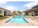 Expansive backyard featuring a large pool with spa, outdoor kitchen, patio, seating and green landscaping at 8369 Eagle Estates Ct, Las Vegas, NV 89131