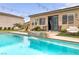 Beautiful backyard oasis with pool, waterfall feature, lounge chairs, and cozy outdoor seating at 8369 Eagle Estates Ct, Las Vegas, NV 89131
