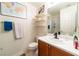 Well-lit bathroom with floating shelves, vanity with modern faucet, and a shower-tub combo with glass doors at 9105 Captivating Ave, Las Vegas, NV 89149