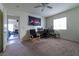 Bright bedroom with carpet flooring, ceiling fan, and ample space for a desk and dresser at 9105 Captivating Ave, Las Vegas, NV 89149