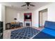 Spacious living room features a ceiling fan, wood laminate flooring, and a decorative fireplace at 9105 Captivating Ave, Las Vegas, NV 89149