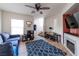 Comfortable living room with ceiling fan, wood laminate flooring, and decorative fireplace, ideal for relaxing at 9105 Captivating Ave, Las Vegas, NV 89149