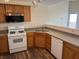 Bright kitchen featuring wood cabinetry, laminate countertops, and modern appliances at 9303 Gilcrease Ave # 2164, Las Vegas, NV 89149