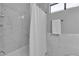 Bathroom featuring a white-tiled tub and shower area at 9625 Beach Water Cir, Las Vegas, NV 89117