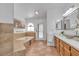 Bathroom featuring bathtub, tiled floors, double sinks, and natural light at 9625 Beach Water Cir, Las Vegas, NV 89117