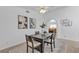 Well-lit dining area with dark wood table set and stylish artwork at 9625 Beach Water Cir, Las Vegas, NV 89117