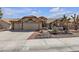 Charming single-story home featuring a three car garage and desert landscaping at 9625 Beach Water Cir, Las Vegas, NV 89117