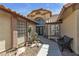 Inviting front entrance with desert landscaping and a decorative iron front door at 9625 Beach Water Cir, Las Vegas, NV 89117