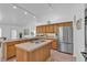 Bright kitchen with stainless steel appliances, kitchen island and wood cabinets at 9625 Beach Water Cir, Las Vegas, NV 89117