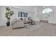 Bright living room featuring vaulted ceilings, large windows, and neutral decor at 9625 Beach Water Cir, Las Vegas, NV 89117