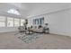Bright living room featuring vaulted ceilings, large windows, and neutral carpet at 9625 Beach Water Cir, Las Vegas, NV 89117