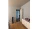 Bedroom with wood floors features a chest of drawers and view into hallway at , Las Vegas, NV 89108