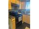 Traditional kitchen featuring wood cabinets, dark countertops, and modern black appliances at , Las Vegas, NV 89108