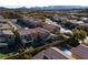 Aerial view showcasing homes with well-manicured lawns and a sparkling private swimming pool at 1015 Solana Crest St, Henderson, NV 89052