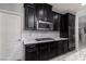 Modern kitchen design featuring stainless steel appliances, dark cabinetry, and stylish backsplash at 1015 Solana Crest St, Henderson, NV 89052