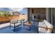 Inviting outdoor patio features a stone fireplace and comfortable seating, perfect for relaxation at 1015 Solana Crest St, Henderson, NV 89052