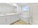 Well-lit bathroom with double vanity, shower, and soaking tub at 10165 Canyon Mantle St, Las Vegas, NV 89166