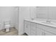 Bathroom featuring a double sink vanity, wood look flooring, and modern fixtures and hardware at 10165 Canyon Mantle St, Las Vegas, NV 89166