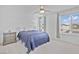 Bedroom featuring carpet floors, a ceiling fan, a bedside table, and a large window at 10165 Canyon Mantle St, Las Vegas, NV 89166