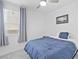 Bright bedroom featuring carpet floors, a ceiling fan, and a window with light-blocking blinds at 10165 Canyon Mantle St, Las Vegas, NV 89166