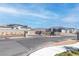 Image of the community entrance with a gate and modern homes with solar panels in the background at 10165 Canyon Mantle St, Las Vegas, NV 89166