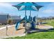 Community playground with slide, shade structure, picnic tables and grassy area at 10165 Canyon Mantle St, Las Vegas, NV 89166
