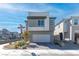 Contemporary two-story home featuring a brick driveway and a neutral-colored exterior, situated in a modern neighborhood at 10165 Canyon Mantle St, Las Vegas, NV 89166