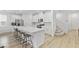 Bright, modern kitchen featuring white cabinets, stainless steel appliances, and an island with seating and sink at 10165 Canyon Mantle St, Las Vegas, NV 89166