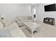 Bright living room showcases neutral furniture, a wall-mounted TV, and open access to adjacent rooms at 10165 Canyon Mantle St, Las Vegas, NV 89166