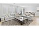 Bright living room features modern gray sofas, stylish area rug, and sliding glass doors to the outdoor space at 10165 Canyon Mantle St, Las Vegas, NV 89166