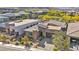 An aerial view of a modern home showcasing the detailed desert landscaping, stone facade and neighborhood at 10348 Bressana Dr, Las Vegas, NV 89135