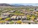 The image captures the picturesque community, complete with green spaces, against a mountain backdrop at 10348 Bressana Dr, Las Vegas, NV 89135