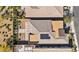 Birds eye view of the roof, the landscaped backyard with synthetic grass and lounge area at 10348 Bressana Dr, Las Vegas, NV 89135
