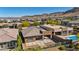 A beautiful backyard featuring a sparkling pool and stunning desert landscaping, framed by distant mountains at 10348 Bressana Dr, Las Vegas, NV 89135