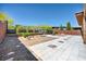 Beautifully landscaped backyard with decorative rock, artificial turf, and a brick retaining wall at 10348 Bressana Dr, Las Vegas, NV 89135