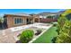 Well-designed backyard featuring a mix of hardscape and landscaping elements, including gravel and artificial turf at 10348 Bressana Dr, Las Vegas, NV 89135