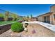 Beautifully landscaped backyard featuring decorative rocks, pavers and synthetic grass at 10348 Bressana Dr, Las Vegas, NV 89135