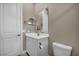 Bathroom with a white vanity, tiled floors, a toilet, and neutral walls with a large mirror at 10348 Bressana Dr, Las Vegas, NV 89135